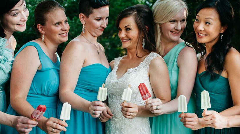 Bride and bridesmaids lined up with streetpops – We do I do's for bridal parties and Cincinnati weddings
